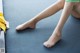 A close up of a woman's legs on a blue mat.