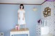 A woman standing on top of a dresser in a room.