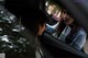 A woman looking out the window of a car.