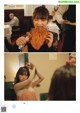 A woman eating a piece of fried chicken in a restaurant.