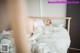 A woman laying in bed with her head on the pillow.