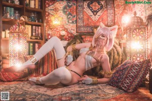 A woman in a cat costume laying on a rug.